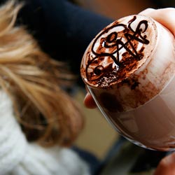 elegant hot chocolate with swirl top in a blonde girls hand