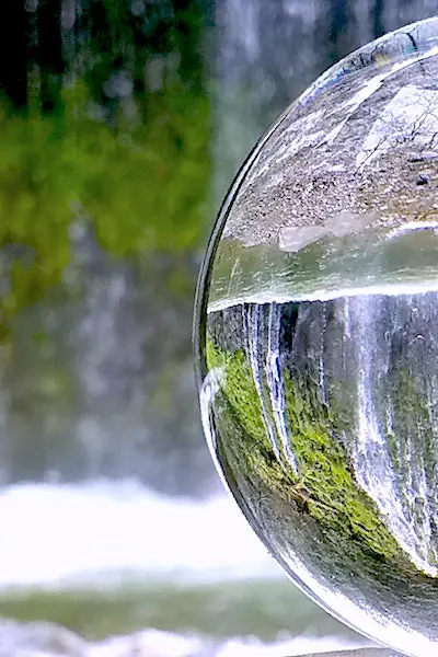 get into flow state glass sphere by waterfall