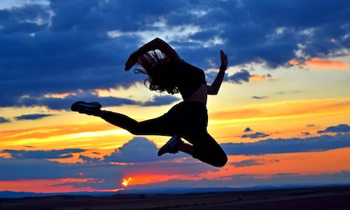 cardio exercise weights live longer woman jumping at sunset
