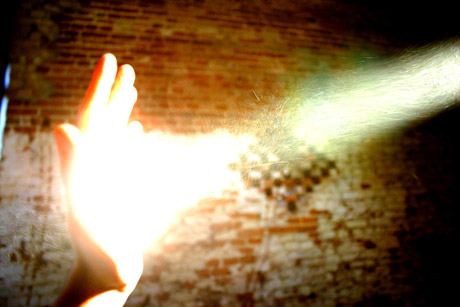 hand light beam particles brick wall miracle iron man