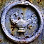 gray ouroboros with lamp grave marker rust
