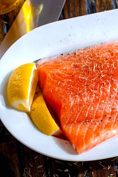 omega 3 fish oil depression preparing salmon filet on white plate