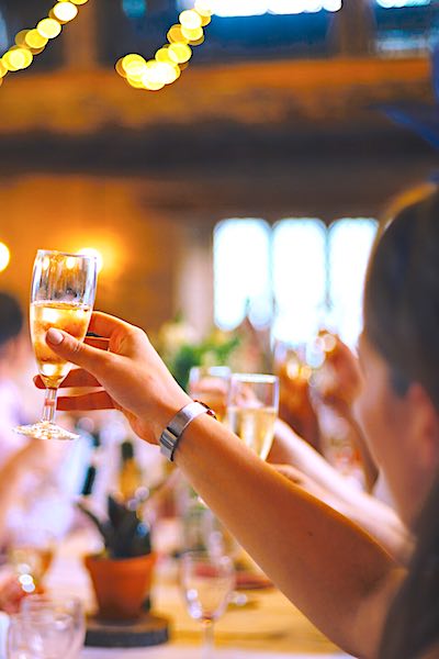 celebration health benefits raising champagne glasses at party