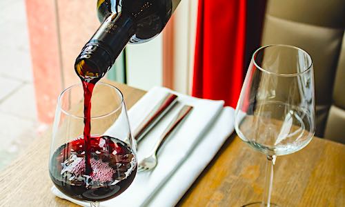 alcohol alzheimers pouring glass of red wine at table