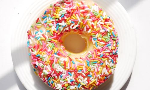junk food brain sprinkle donut on white plate